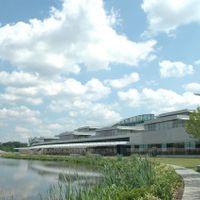 a large, white building at the edge of a body of water