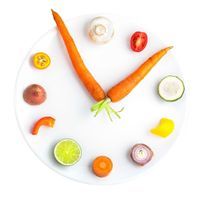 a plate with fruits and vegetables arranged into the shape of a clock