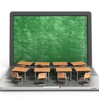 an illustration of a laptop computer with miniature desks and chairs on the keyboard