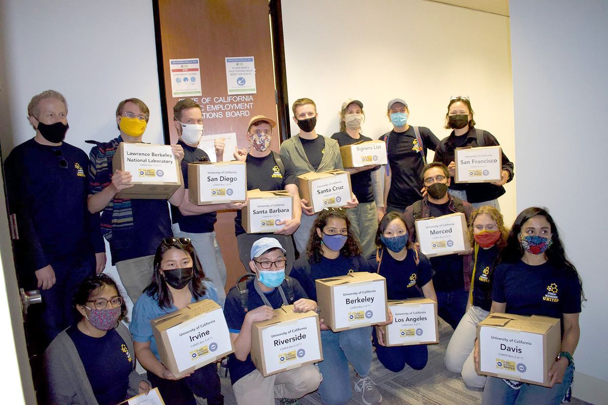 graduate student researchers presenting thousands of signed authorization cards