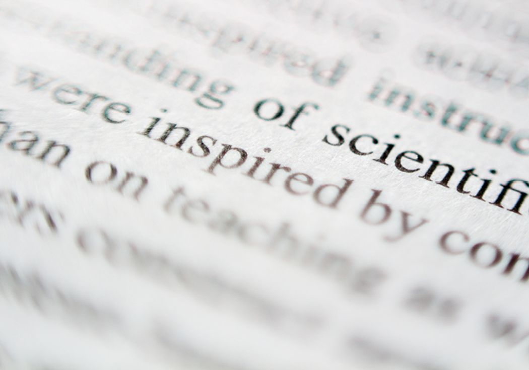 A close-up shot focusing on the word “inspired” printed within a paragraph. A close-up shot focusing on the word “inspired” printed within a paragraph.