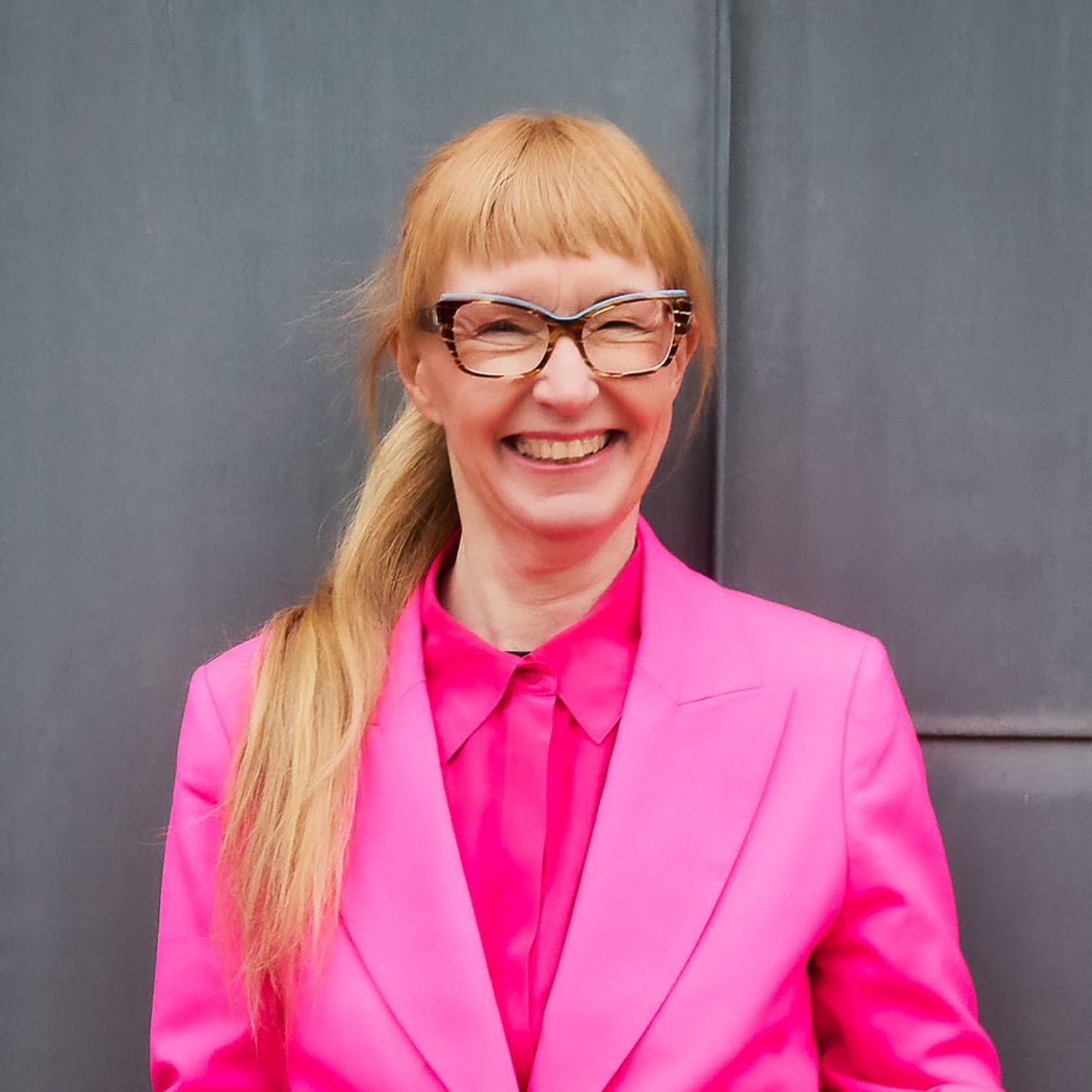 Image of Breakthrough Prize laureate, pharmaceutical scientist Lotte Bjerre Knudsen against a grey background. She wears a pink shirt and blazer and smiles. Image of Breakthrough Prize laureate, pharmaceutical scientist Lotte Bjerre Knudsen against a grey background. She wears a pink shirt and blazer and smiles.
