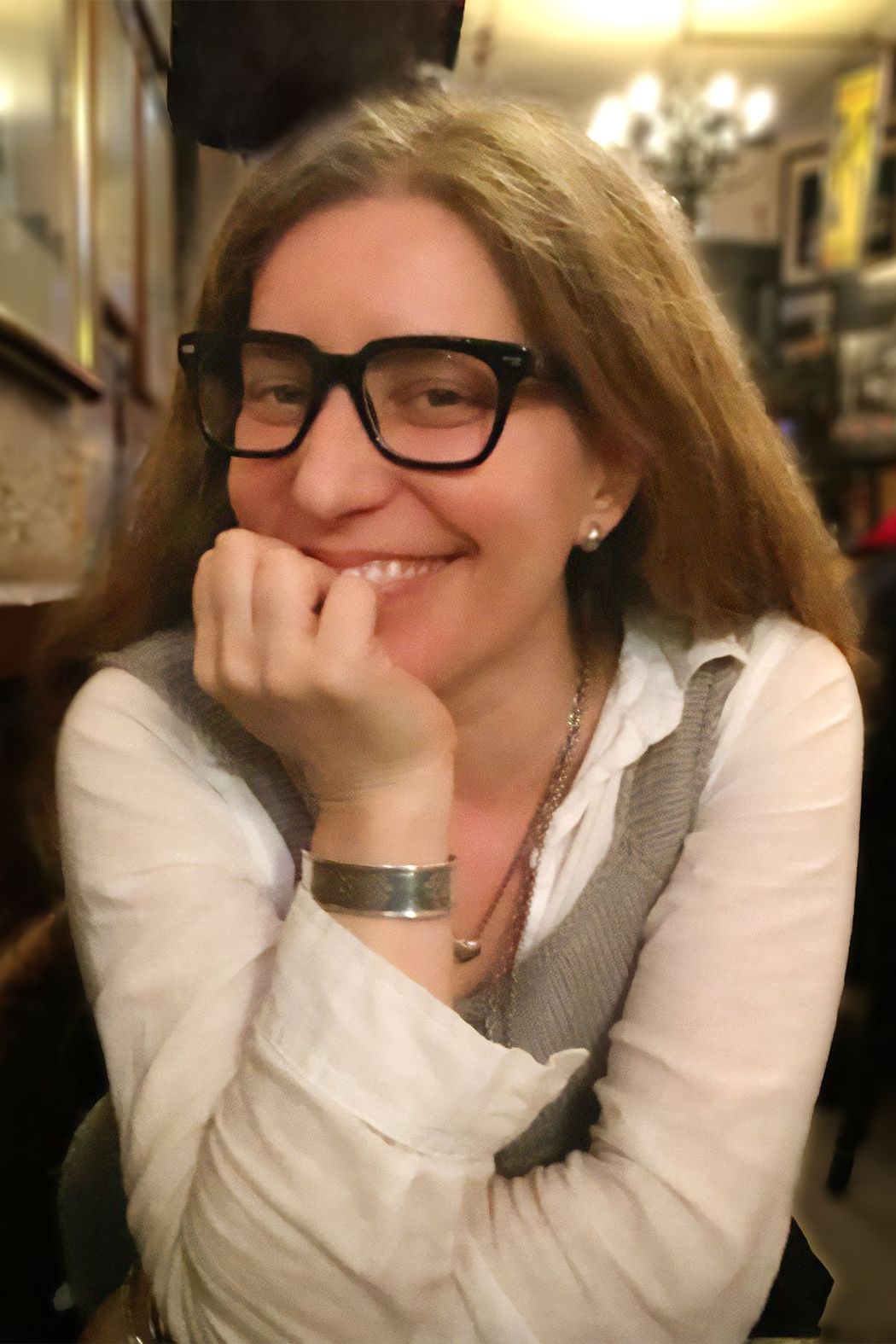 Author Mindy Weisberger wears a white shirt and black-rimmed glasses and smiles at the camera. Author Mindy Weisberger wears a white shirt and black-rimmed glasses and smiles at the camera.