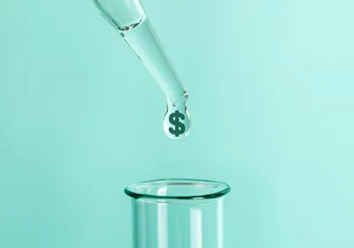 Illustration of a pipette tip releasing a drop with a dollar sign into a test tube on a teal background.
