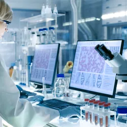 Scientists work on a computer, focusing on leukemia treatment using menin inhibitors.