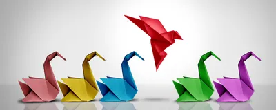 A group of intricately folded origami swans, with one soaring above, symbolizing revolutionary ideas.