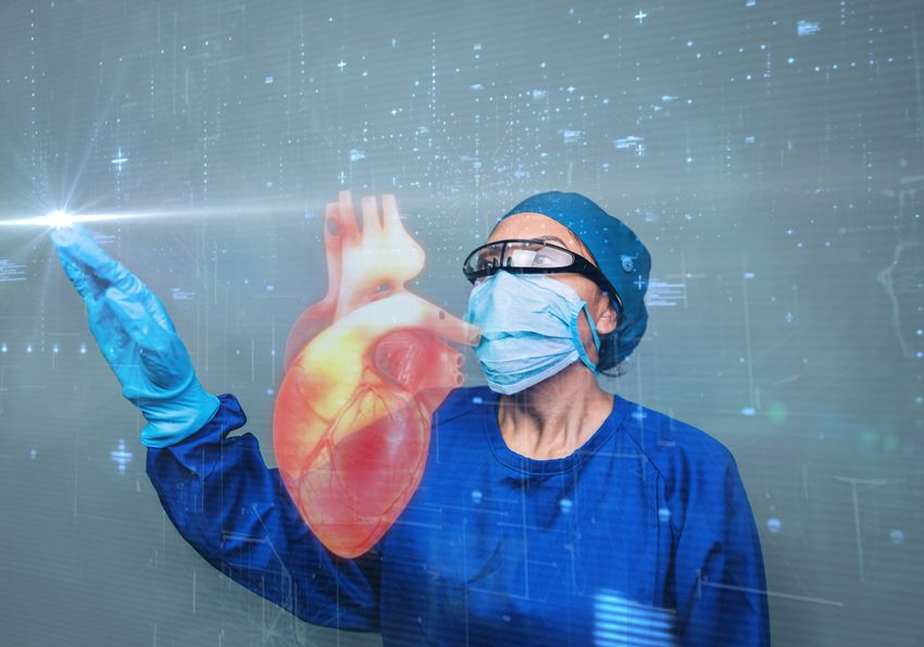 A surgeon examines a heart displayed on a screen A surgeon examines a heart displayed on a screen