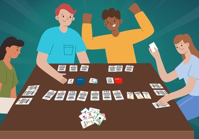 An image of young researchers gathered around a table playing an engaging board game.