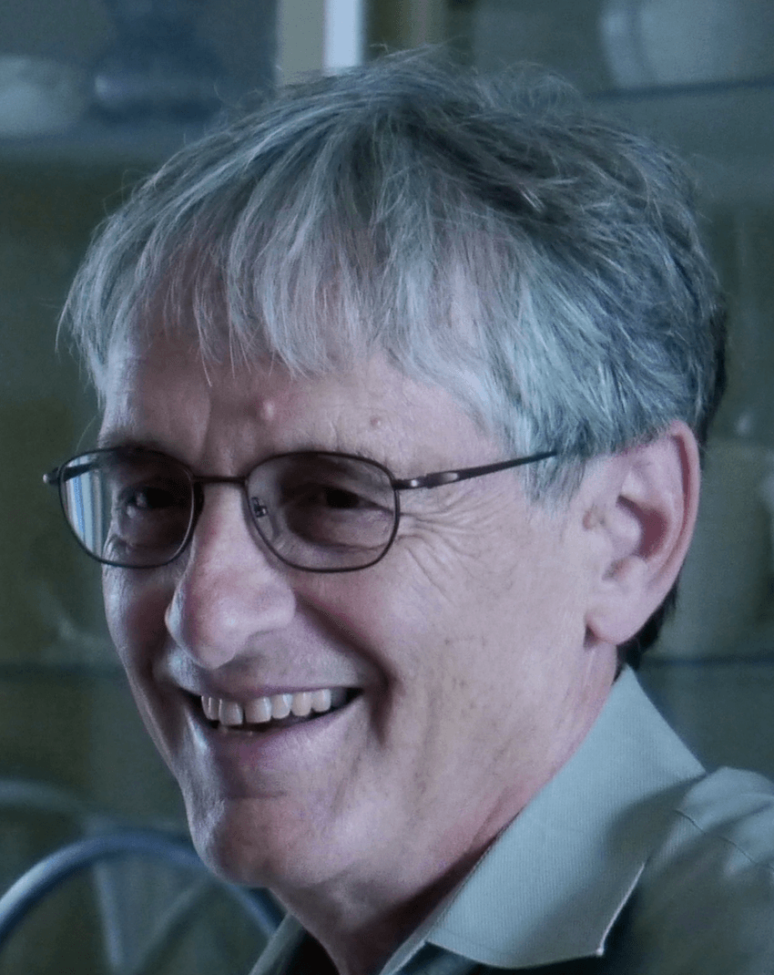 Candid image of Steven Rosen, wearing glasses and collared green shirt, laughing. Candid image of Steven Rosen, wearing glasses and collared green shirt, laughing.