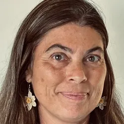 Photograph of Mary Meyer. She has brown hair and is wearing dangling flower earrings. 