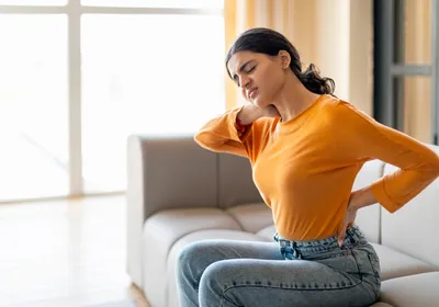 A young woman with neck and back pain.