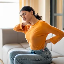 A young woman with neck and back pain.