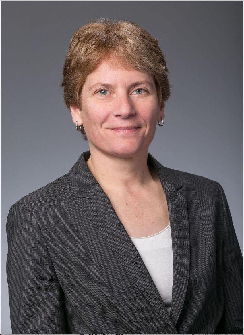 Carolyn Bertozzi wears a grey blazer and a white top in a headshot. Carolyn Bertozzi wears a grey blazer and a white top in a headshot.