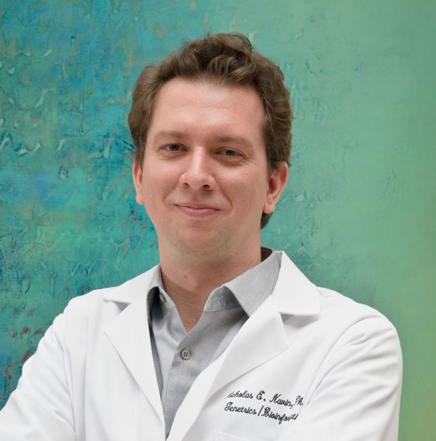 Professional of photograph of Nicholas Navin with a background that shifts from blue to green. He has short brown hair and is wearing a white lab coat with a grey collared shirt underneath. Professional of photograph of Nicholas Navin with a background that shifts from blue to green. He has short brown hair and is wearing a white lab coat with a grey collared shirt underneath.