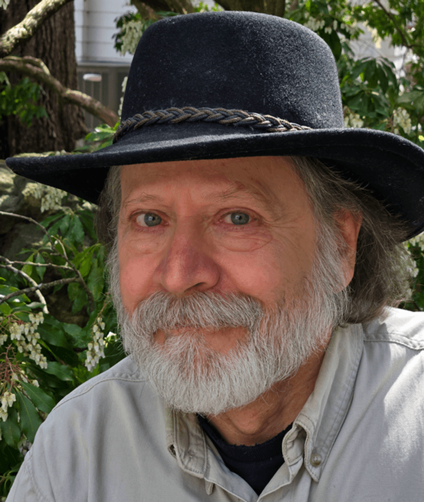 Image of James Traniello, wearing a black hat and light grey shirt, in front of plants. Image of James Traniello, wearing a black hat and light grey shirt, in front of plants.