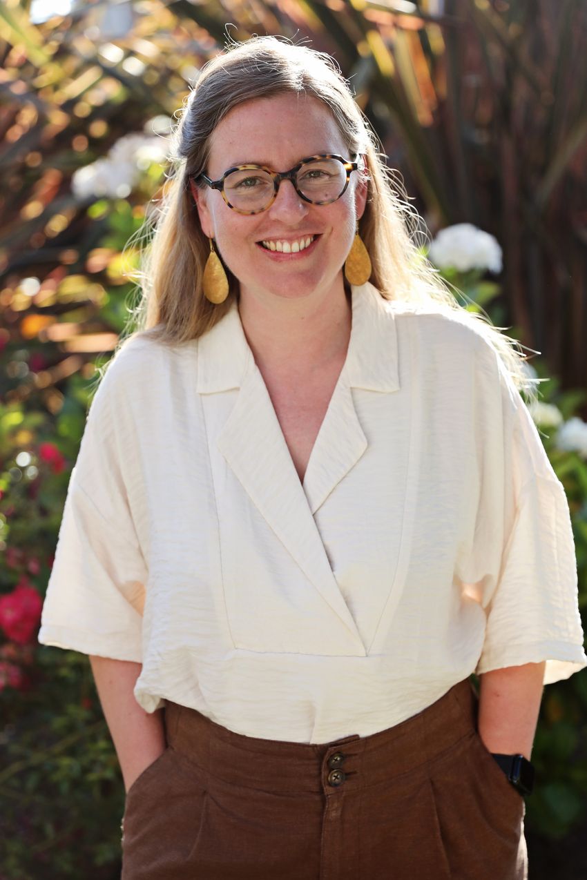 Christina Warinner’s photo against a natural background. She wears a beige top, brown pants, glasses, and smiles at the camera. Christina Warinner’s photo against a natural background. She wears a beige top, brown pants, glasses, and smiles at the camera.