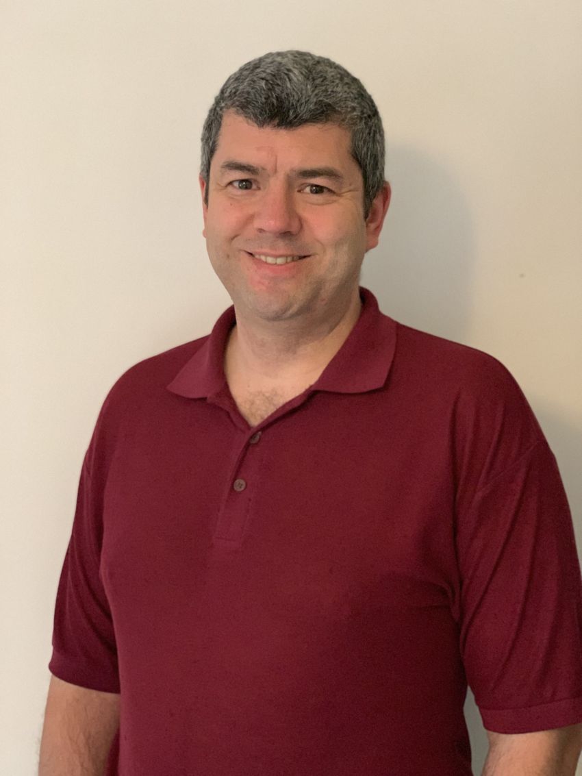 Image of David Hone, wearing a red polo, on a white background.