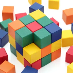 A photo of colorful cube-shaped wooden blocks stacked into a cube.