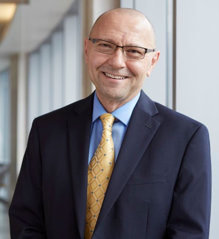 A photo of Dan Theodorescu, standing in front of a row of windows. Credit: Cedars-Sinai Health System