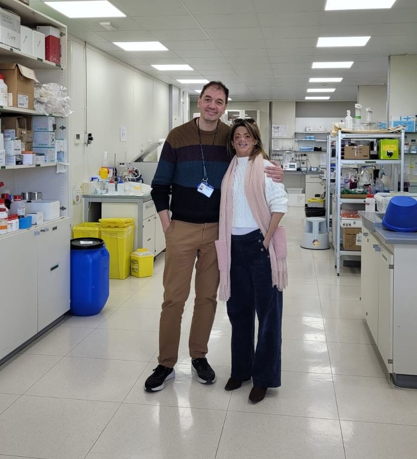A man and a woman are standing together in a rare disease research lab. A man and a woman are standing together in a rare disease research lab.