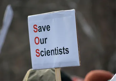  A paper protest sign reads “Save Our Scientists”, signifying the crisis that US scientists are facing due to severe federal research funding cuts.