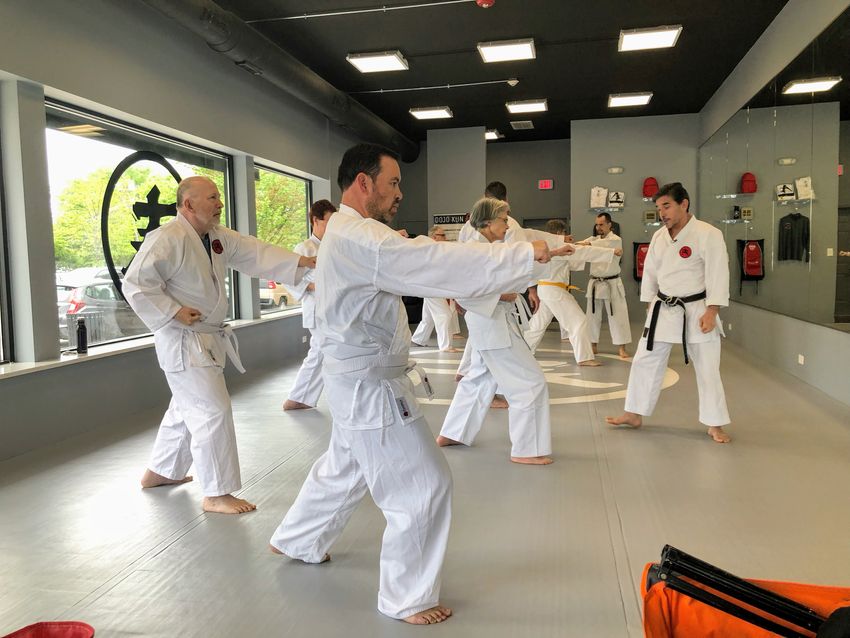 Image of a group of men and women in a karate dojo.