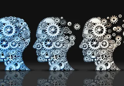 3D illustration of human heads made of gears and machine cog wheels degrading to demonstrate neurodegeneration and aging.