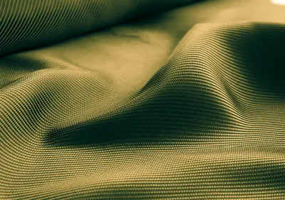 Conceptual background image of rippling gold material.