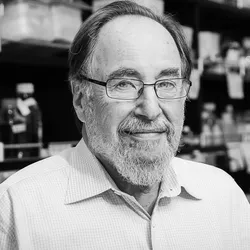 A picture of David Baltimore, a renowned molecular biologist and Nobel Laureate. 