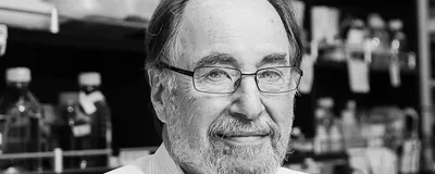 A picture of David Baltimore, a renowned molecular biologist and Nobel Laureate. 