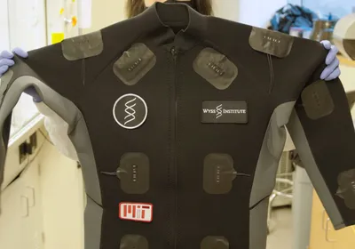 A person holds a smart suit embedded with wearable sensors developed by scientists at the Wyss Institute. A person holds a smart suit embedded with wearable sensors developed by scientists at the Wyss Institute.