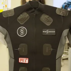A person holds a smart suit embedded with wearable sensors developed by scientists at the Wyss Institute. A person holds a smart suit embedded with wearable sensors developed by scientists at the Wyss Institute.