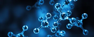 An abstract illustration of clear molecules in front of a dark blue background. An abstract illustration of clear molecules in front of a dark blue background.