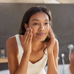 A woman applying cream to her face. The skin stretching in this process could stimulate immune surveillance and open up hair follicles. A woman applying cream to her face. The skin stretching in this process could stimulate immune surveillance and open up hair follicles.
