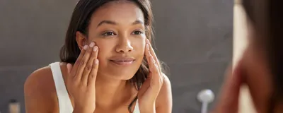 A woman applying cream to her face. The skin stretching in this process can stimulate immune surveillance and open up hair follicles. A woman applying cream to her face. The skin stretching in this process can stimulate immune surveillance and open up hair follicles.