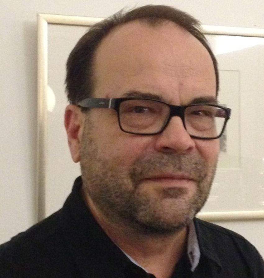 Pekka Karhunen, a physician-scientist at Tampere University, wears a black shirt and smiles at the camera.