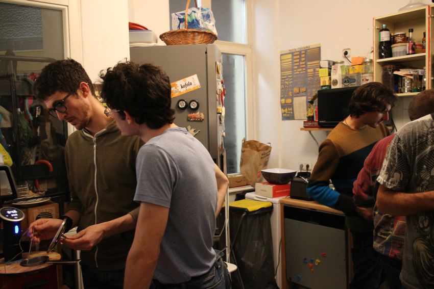 The researchers work together in one of their kitchens on their cacio e pepe experiments.