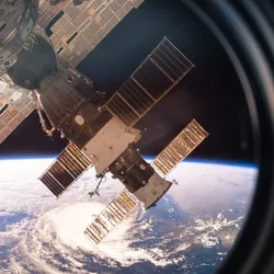 Image of a circular window on the International Space Station (ISS). The view includes planet Earth and parts of the ISS. Image of a circular window on the International Space Station (ISS). The view includes planet Earth and parts of the ISS.
