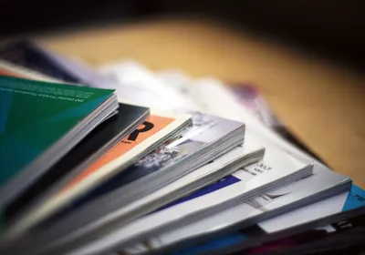 Scientific journals are spread out on top of a table. Scientific journals are spread out on top of a table.