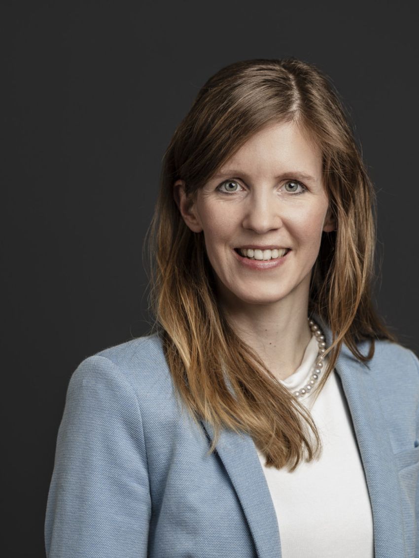 A photograph of Inge Herrmann, who developed a smart pad that can detect disease biomarkers in menstrual blood, wearing a white top and grey blazer.