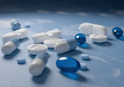 Various types of pills in blue and white lying on a blue background Various types of pills in blue and white lying on a blue background