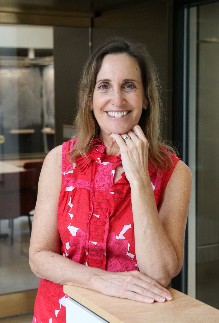 Bonnie Berger poses with her left hand propped under her chin and her right hand on a countertop. She’s wearing a red and white sleeveless shirt with floral patterns. Bonnie Berger poses with her left hand propped under her chin and her right hand on a countertop. She’s wearing a red and white sleeveless shirt with floral patterns.
