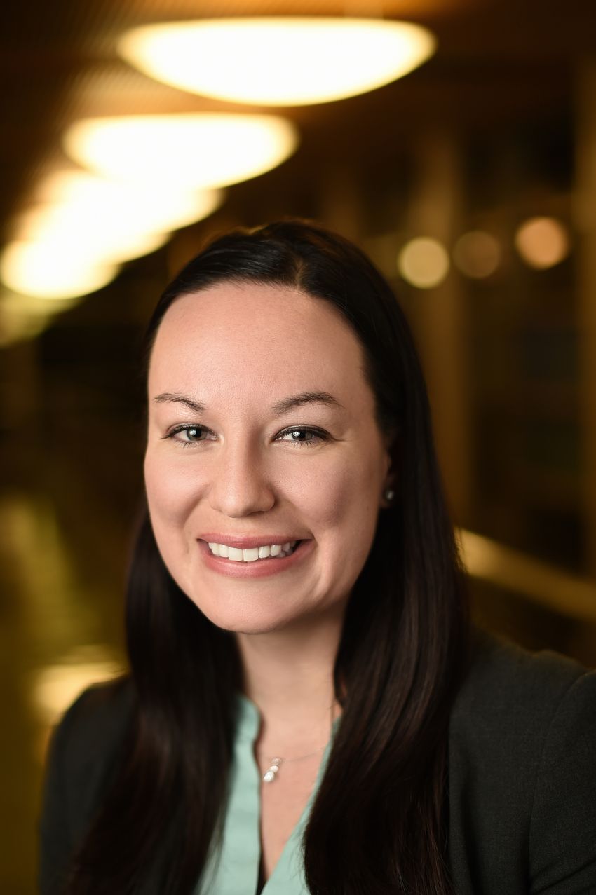 Carolyn Schutt Ibsen, a biomedical engineer at Oregon Health and Science University (OHSU), smiles at the camera. She’s wearing a black jacket over a light blue/green shirt.