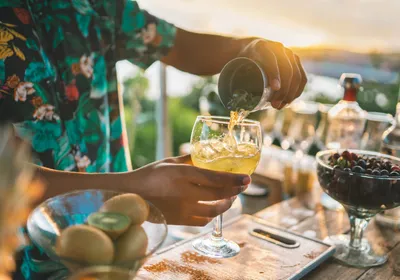 Bartender preparing a cocktail outdoors. Bartenders often suffer from margarita burns.