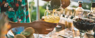 Bartender preparing a cocktail outdoors. Bartenders often suffer from margarita burns. Bartender preparing a cocktail outdoors. Bartenders often suffer from margarita burns.