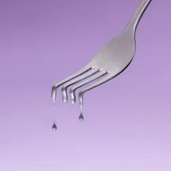 An illustration of fork with the tip of its tines melting against a purple background. An illustration of fork with the tip of its tines melting against a purple background.