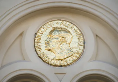 A photo of a gold plaque depicting Alfred Nobel.