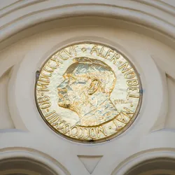 A photo of a gold plaque depicting Alfred Nobel.
