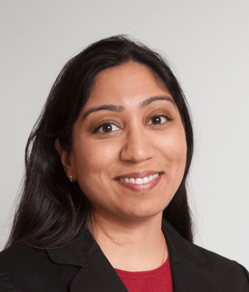 Photograph of Sarita Patil, who researches and treats people with exercise-induced urticaria and anaphylaxis, wearing a red top and black coat. Photograph of Sarita Patil, who researches and treats people with exercise-induced urticaria and anaphylaxis, wearing a red top and black coat.