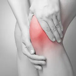 Two hands massaging a knee, indicating pain.